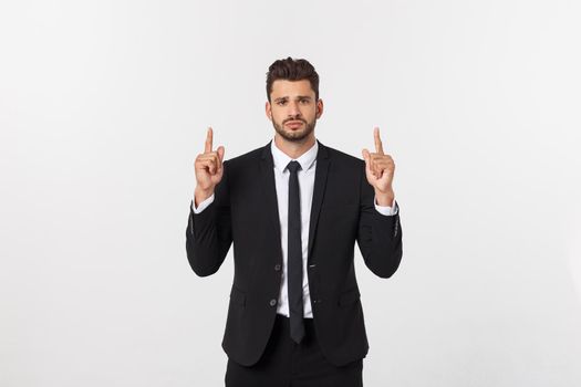 Business Concept: Portrait handsome young businessman point finger on side to empty copy space. Isolated over white background.