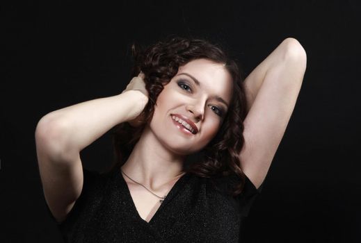 beautiful woman with evening make-up sitting in a chair.isolated on black background