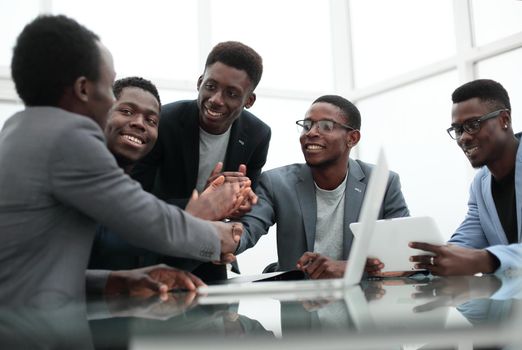 group of employees looking at the screen of a digital tablet. the concept of a startu