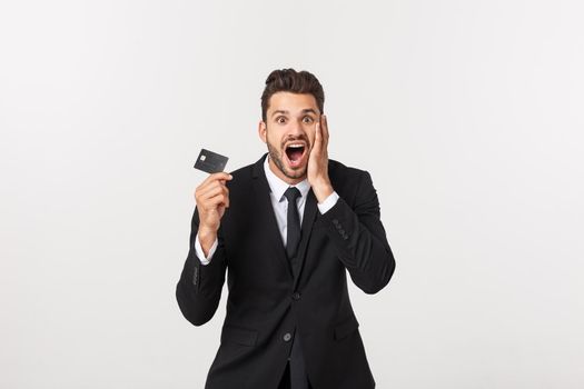 Surprised, speechless and impressed handsome caucasian businessman in classic suit showing credit card, say wow, standing white background astonished.