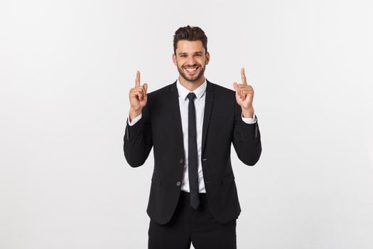 Young businessman celebrating his success over gray background