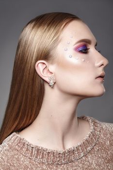 Beautiful Woman with Professional Creative Makeup with Perls. Celebrate Style Eye Make-up, Perfect Eyebrows, Shine Skin. Bright Fashion Look. Glow Skin with Shimmer