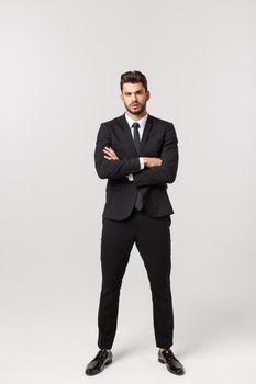 Photo of an attractive businessman with his arms crossed and smiling over a white background