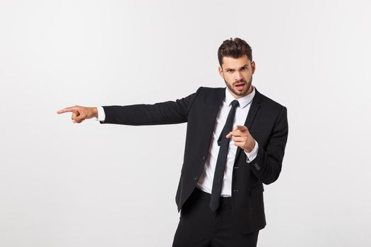 Portrait businessman angry and pointing finger at you over isolated white background.