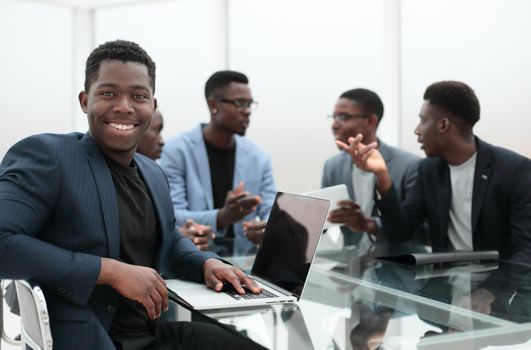 young businessman uses laptop sitting at office Desk. business concept