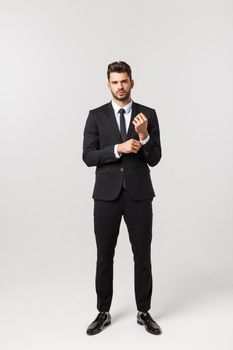 Photo of an attractive businessman posting over a white background