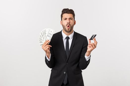 Surprised, speechless and impressed handsome caucasian businessman in classic suit showing credit card, say wow, standing white background astonished.