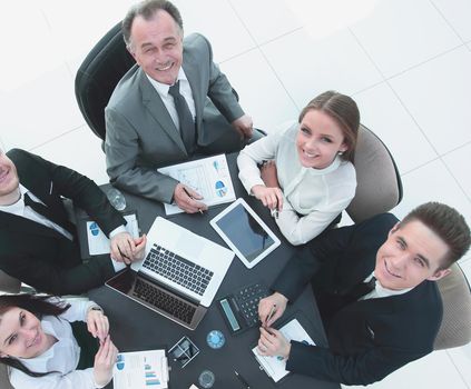 top view.business team at a Desk looking at the camera.the concept of teamwork