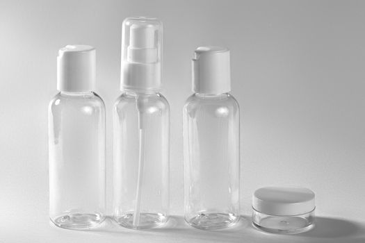 White cosmetic bottles on white background. Wellness, spa and body care bottles collection. Beauty treatment, bathroom set