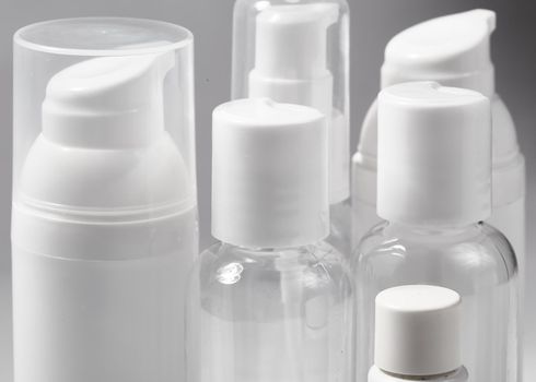White cosmetic bottles on white background. Wellness, spa and body care bottles collection. Beauty treatment, bathroom set