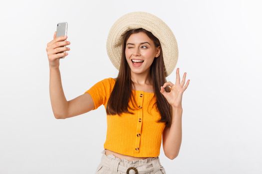 Young Caucasian woman enjoying the selfie with herself isolated on white background summer travel concept