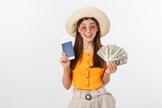 Portrait of cheerful, happy, laughing girl with hat on head, having money fan and passport with tickets in hands, isolated on white background.