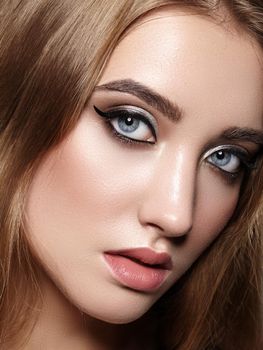 Beautiful Woman with Professional Makeup. Celebrate Style Eye Make-up, Perfect Eyebrows, Shine Skin. Bright Fashion Look. Black Liner, Shimmer Powder and Silver Eyeshadows