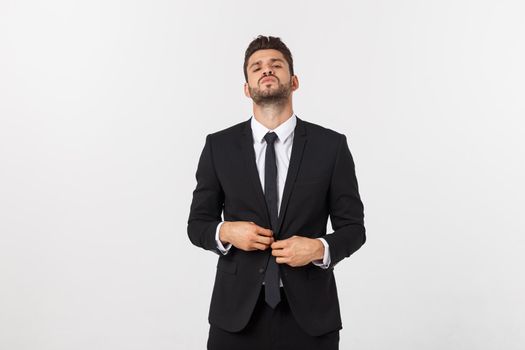 Portrait of a confident man in business suit, fixing his tie.