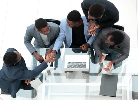 top view. business colleagues shaking hands during office meeting. the concept of cooperation