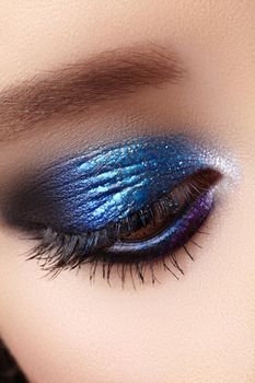 Closeup Macro of Woman Fashion Make-up of Eyes. Glitter Blue Celebrate Makeup, Perfect Color of Eyeshadows. Long Lashes.