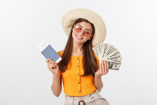 Portrait of cheerful, happy, laughing girl with hat on head, having money fan and passport with tickets in hands, isolated on white background.