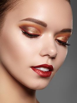 Beautiful Woman with Professional Makeup. Luxury Style Eye Make-up, Perfect Eyebrows, Shine Skin. Bright Fashion Look. Gold Color of Eyeshadows. Christmas Celebrate Image