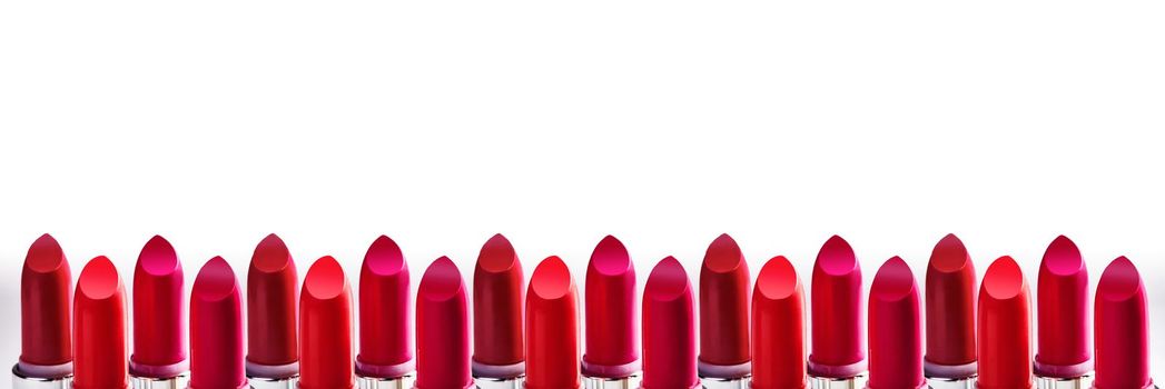 Beautiful set of lipsticks in red colors. Beauty cosmetic collection. Macro close up shot. Fashion trends in cosmetics with bright lips, delisious textures. Salon background