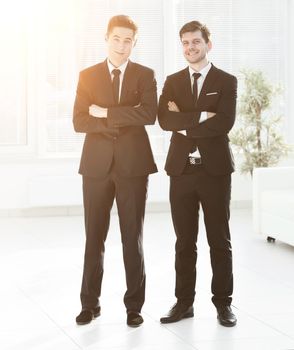 two young business colleagues standing in office.photo in full growth