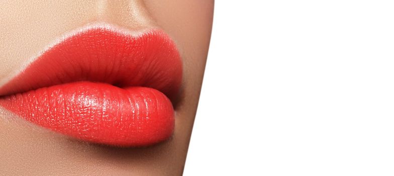 Close-up macro shot of female mouth. Sexy Glamour red lips Makeup with sensuality gesture. Juicy gloss lipstick. Full lips