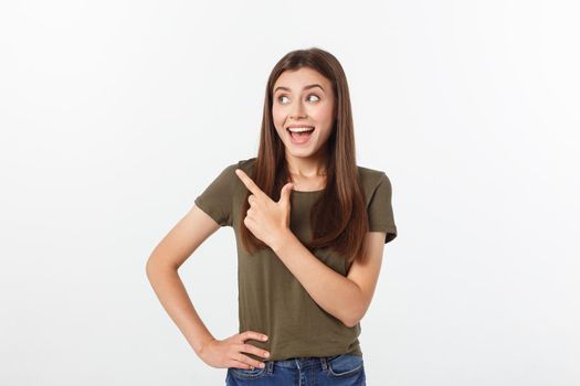 amazement - woman excited looking to the side. Surprised happy young woman looking sideways in excitement. Mixed race Asian and white Caucasian female model on grey background