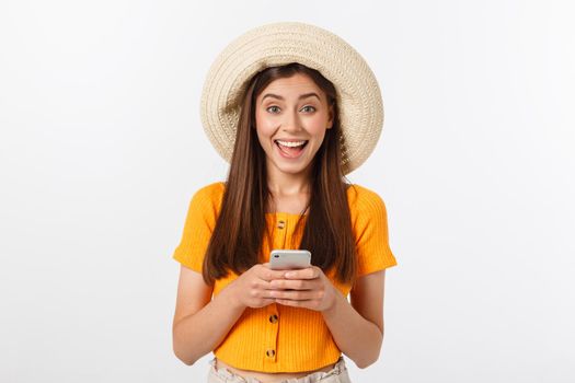 Happy young caucasian woman using smartphone standing isolated on white