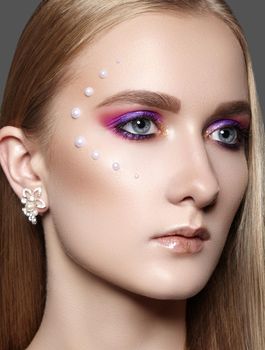 Beautiful Woman with Professional Creative Makeup with Perls. Celebrate Style Eye Make-up, Perfect Eyebrows, Shine Skin. Bright Fashion Look. Glow Skin with Shimmer