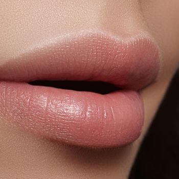 Close-up perfect natural lip makeup beautiful female mouth. Plump sexy full lips. Macro photo face detail. Perfect clean skin, fresh lip make-up. Beautiful spa tender lips