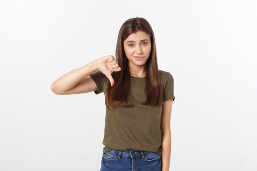 Image of resentful woman with long dark hair showing thumbs down isolated over gray background