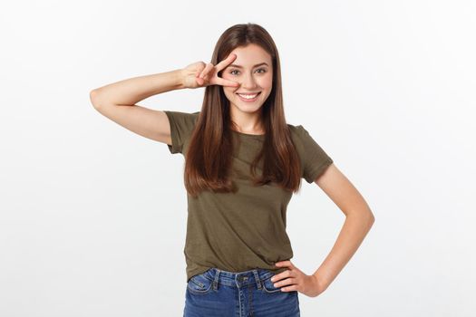 Young woman showing two fingers, positive or peace gesture, on white