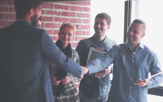 team of copywriters and a handshake of business partners in a creative office.photo with place for text