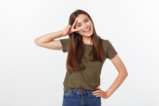 Young woman showing two fingers, positive or peace gesture, on white