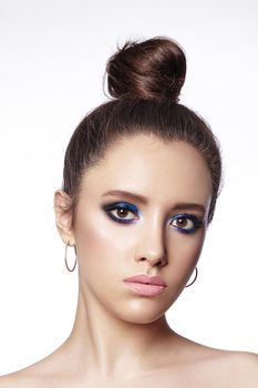 Beautiful Brunette Woman with Fashion Makeup and Bun Hairstyle. Celebrate Style Eye Make-up. Bright Fashion Look.