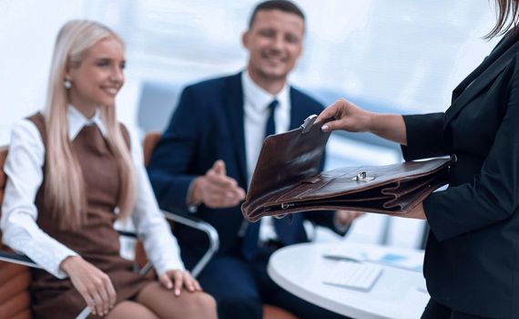 closeup of a lawyer opening briefcase with documents.the business concept . business background