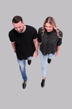 top view. stylish young couple walking together . isolated on white background