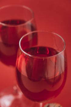 Two wine glasses with red wine on the red background. valentines day. Love and romance