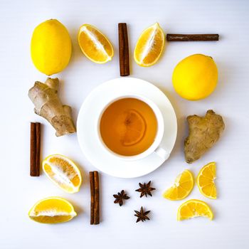 Trendy flat lay Ginger hot immunity boosting Vitamin natural drink With citrus lemon cinnamon anise in a rustic style on white background. Chamomile tea. Healthy concept