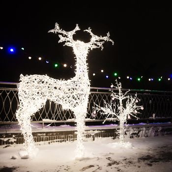 Many Festive Lights Lamps In Shape Deer In Evening Night Festive Illumination. Decorative Streets Elements In Christmas Xmas Holiday Season