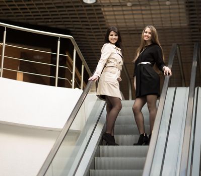 Employees of the company meet the client on the stairs in the foyer of the modern office.