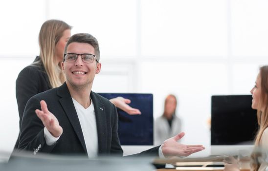 close up. smiling business man sitting at an office Desk.