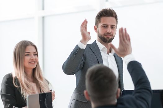 happy employees giving each other a high five. the concept of success.