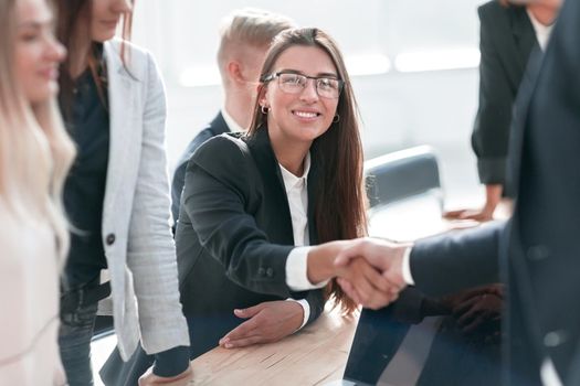 close up. smiling businesswoman shaking hands with her business partner. the concept of cooperation