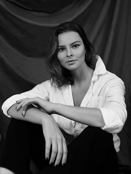 Attractive Sensual Woman is Posing in White Shirt. Black and White Cinematic Portrait with Cute Emotions.