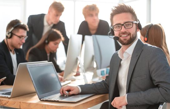 close up. businessman in a headset sitting at an office Desk. the concept of teamwork