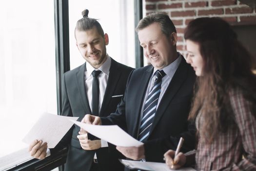 business partners discussing business documents standing in the office.office life