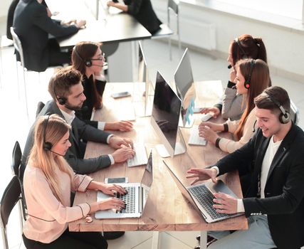 group of employees in a headset work in a modern office. photo with copy-space