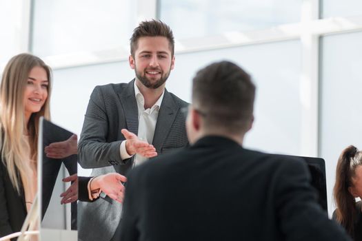 group of employees discussing something standing in the office. office workdays