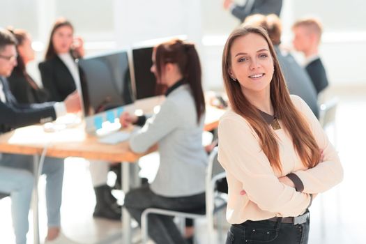 portrait of a young woman standing in a modern office . photo with a copy of the space