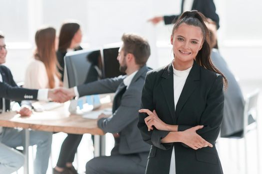 young corporate employee standing in a modern office . photo with a copy of the space